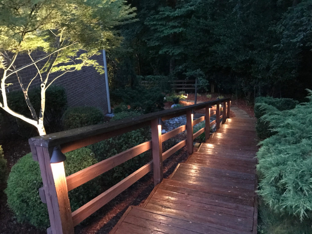 lights on wooden stairs through garden